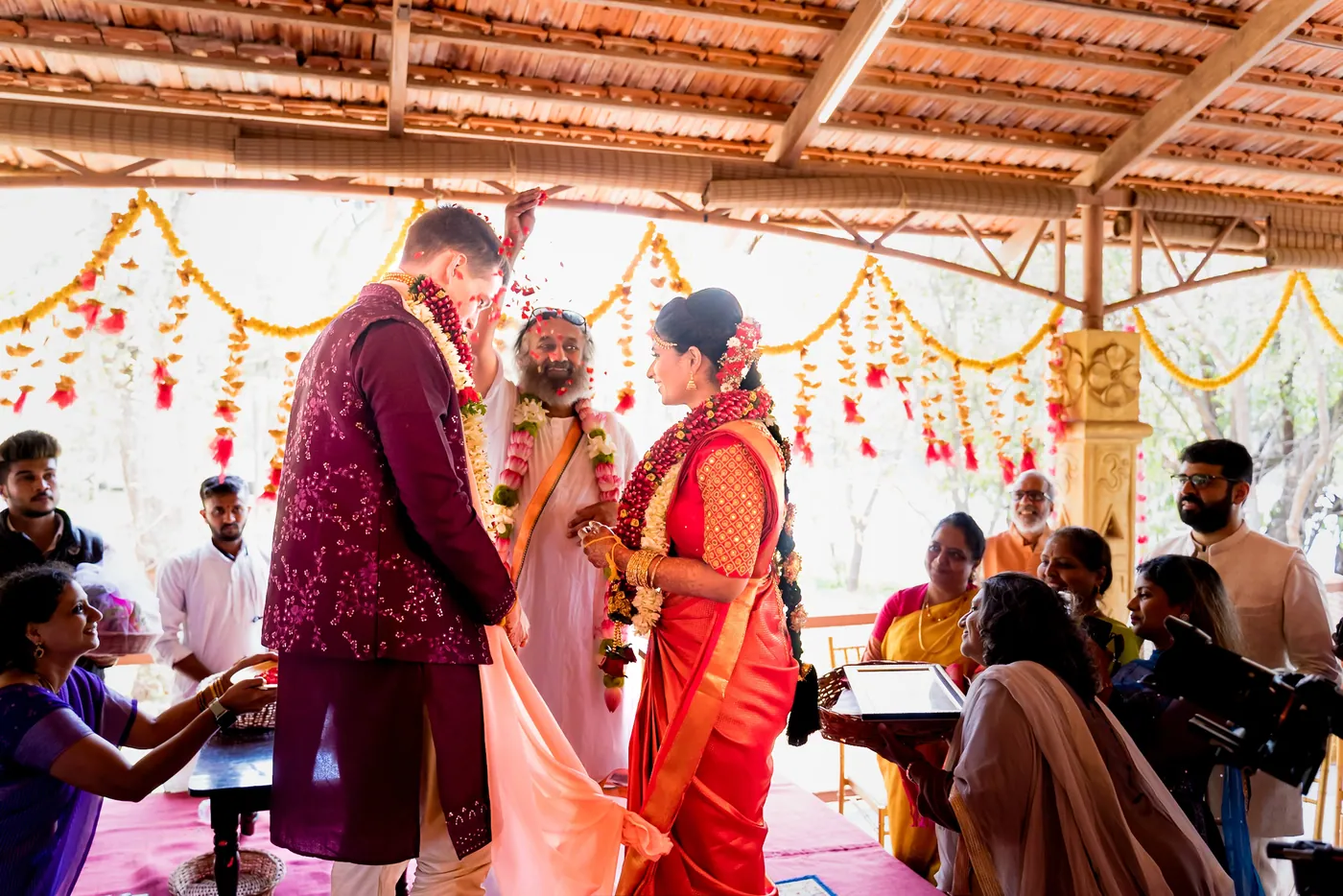 Sri Sri Ravi Shankar blesses Medha and Stefan with flower petals as family and guests gather