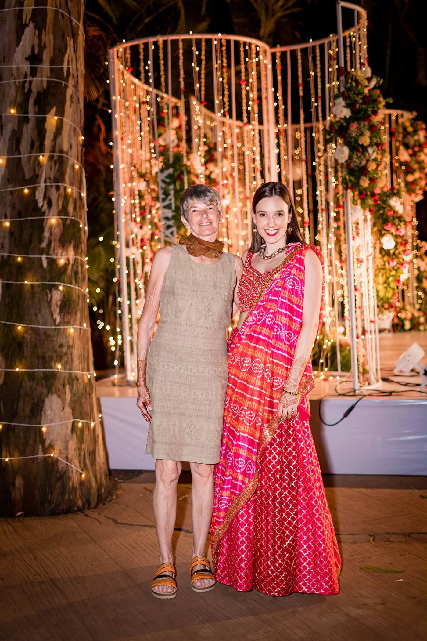 Stefan's mother and his sister pose together in front of the glowing backdrop