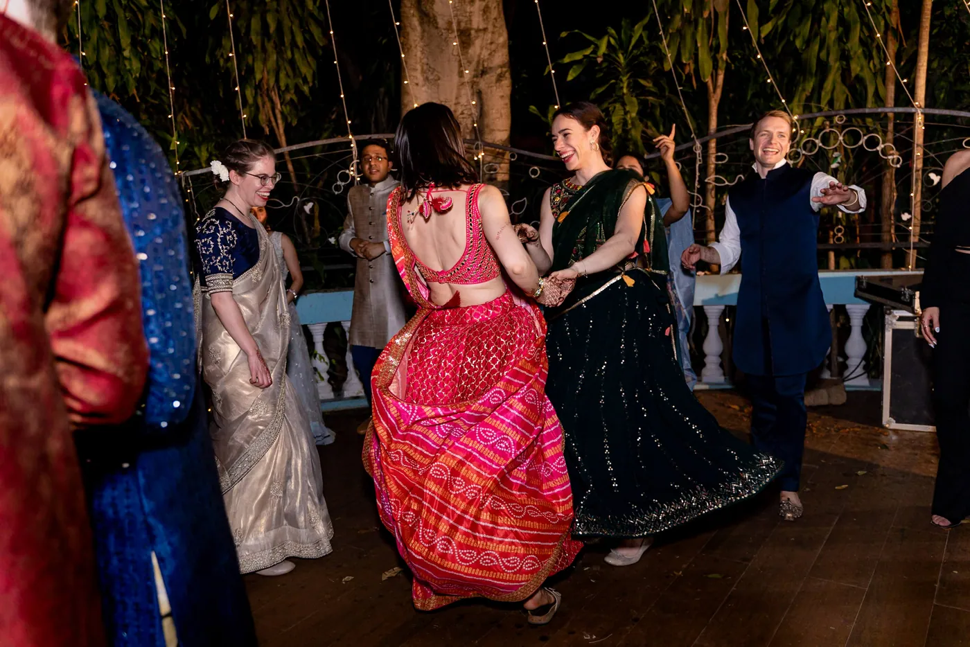 Guests dance in red, pink and green as Stefan appears small at the back